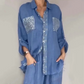 Set bestaande uit een damesblouse met pailletten en een wijde broek
