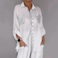 Set bestaande uit een damesblouse met pailletten en een wijde broek