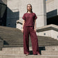 Set bestaande uit een dames-top met korte mouwen en een broek met wijde pijpen