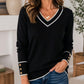 Elegant gebreid dames shirt met V-hals en contrastdetail